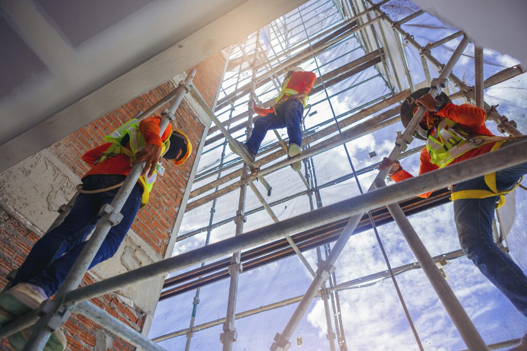 workers climbing scaffolding
